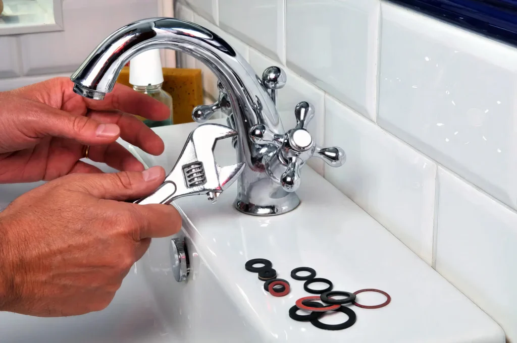 Plumber performing maintenance on a bathroom faucet in Plant City
