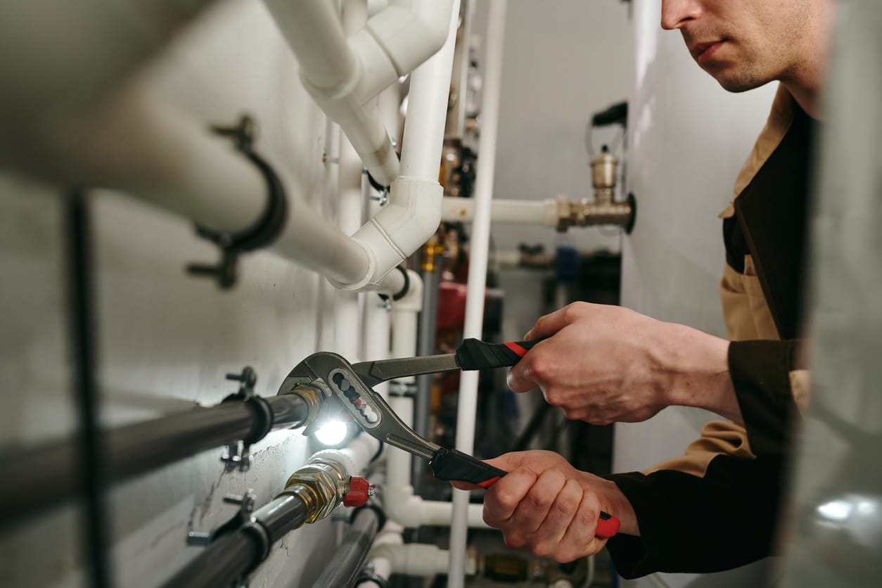 Plumbers maintaining commercial plumbing pipes in Plant City
