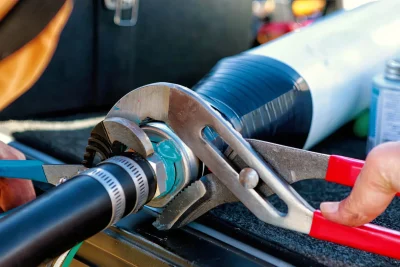 Technician tightening an industrial pipe connection in Plant City