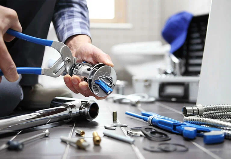 Technician repairing a plumbing fixture with professional tools in Plant City