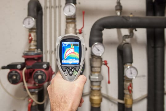 Plumber using a thermal imaging camera to inspect pipes in Plant City