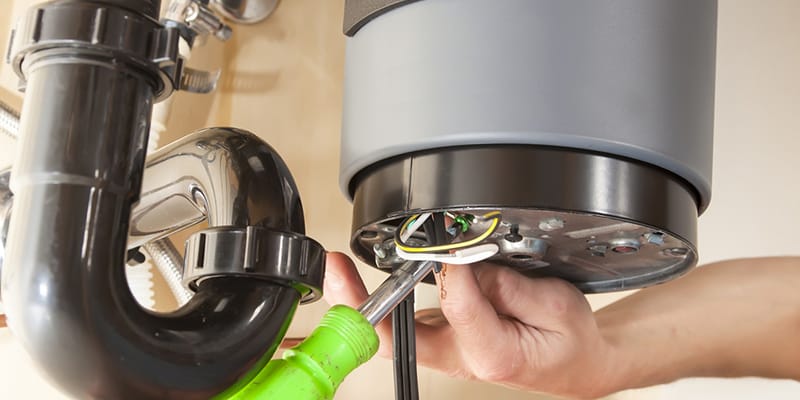 Technician repairing the heating element of a water heater in Plant City