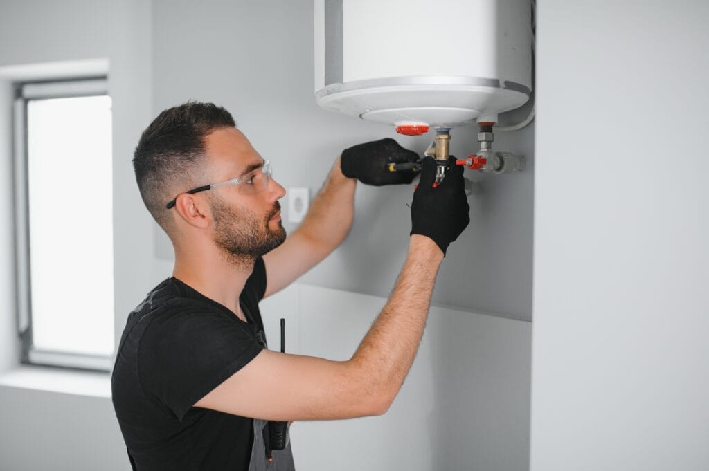 Technician performing water heater maintenance in Plant City