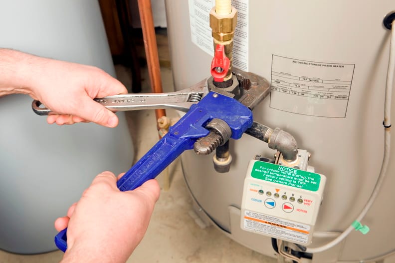Plumber repairing a water heater valve in Plant City